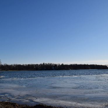 Small lake with partially frozen surface.