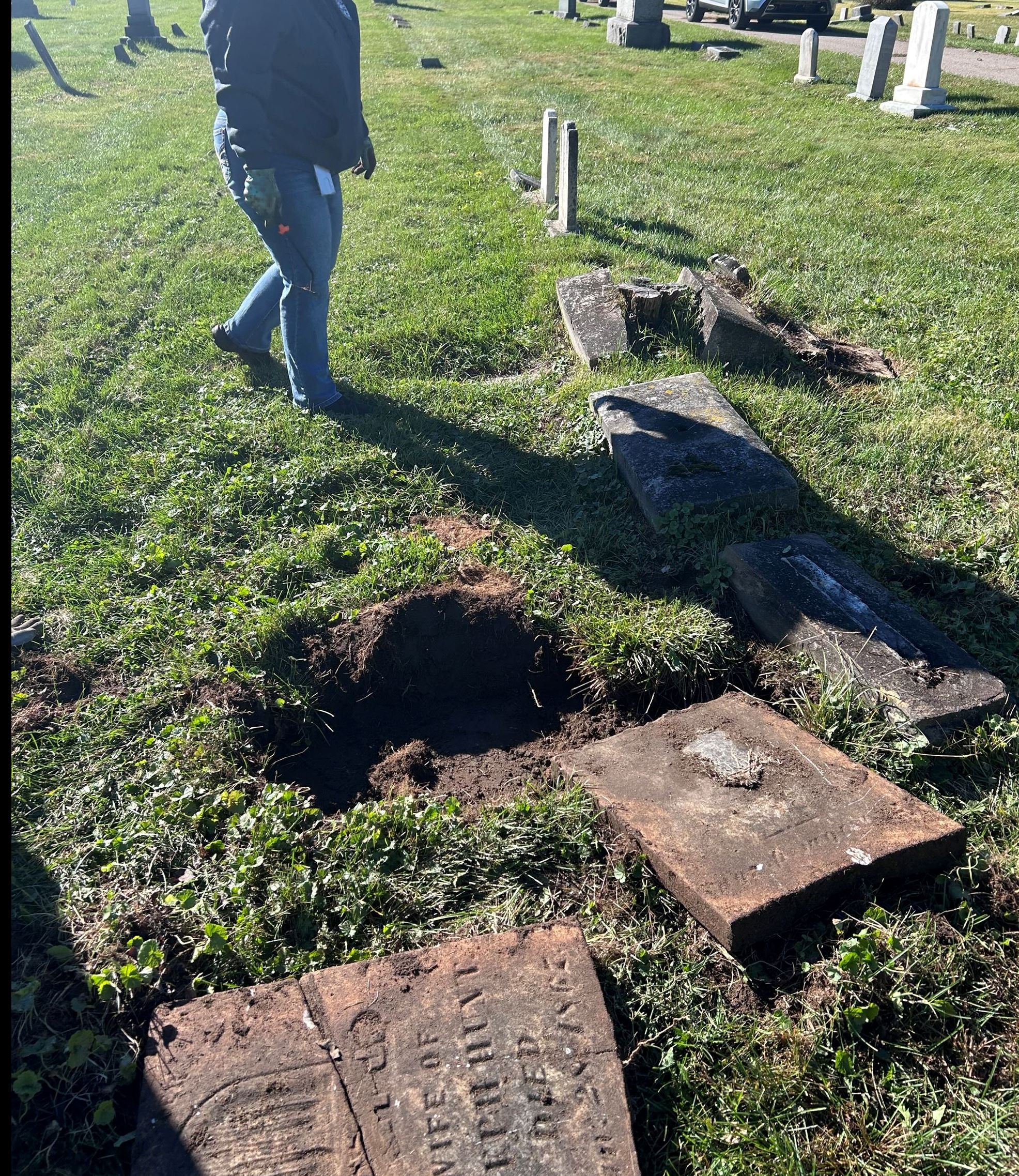 Photo of headstones that were buried under the sod in Youngs Cemetery