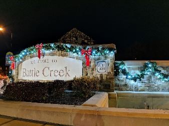 Welcome to Battle Creek fountain at night with holiday lights