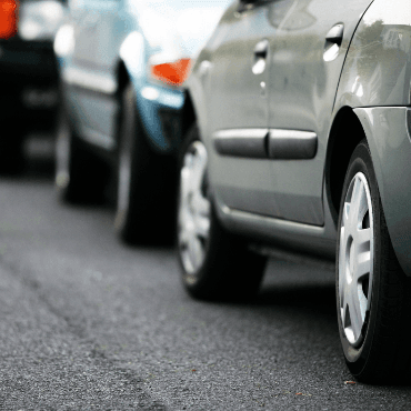 Street level view of cars parallel parked along a street
